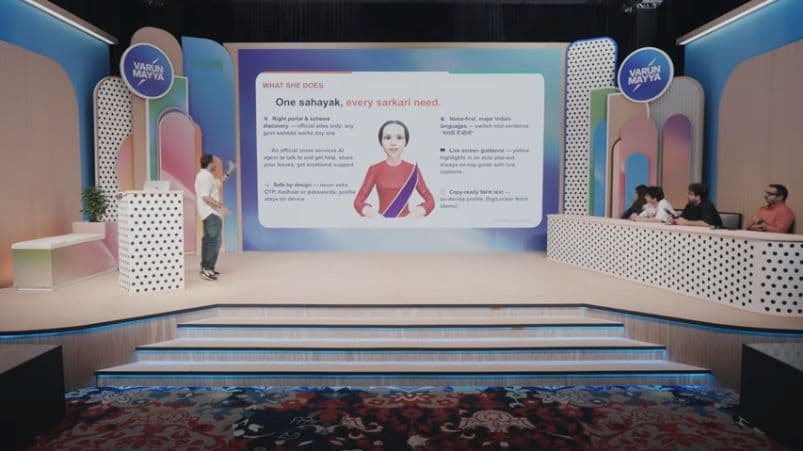 JanSewak presentation on the Build What Moves India stage, with a presenter, slide and judging panel